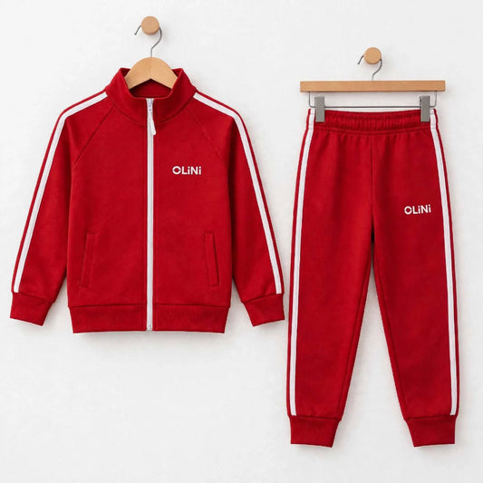 A two-piece kids' tracksuit set consisting of a red zip-up jacket and matching sweatpants, both with white side stripes and the brand name 'OLINI' printed in white on the chest, displayed on wooden hangers against a white wall.